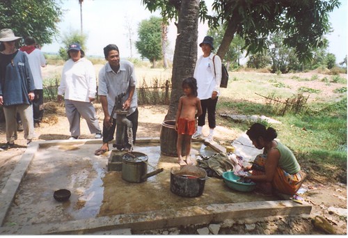 Man pumping, kids watching